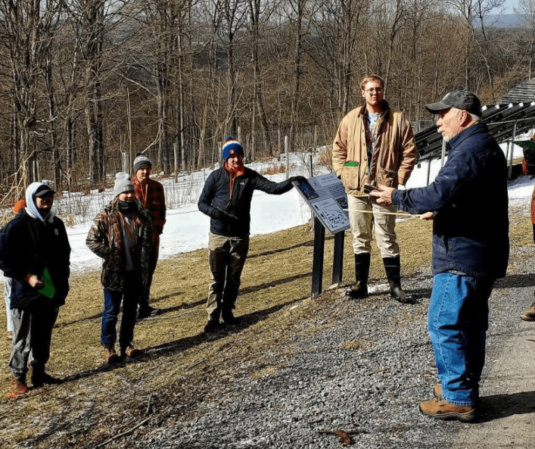 Group of people learning about forestry outdoors