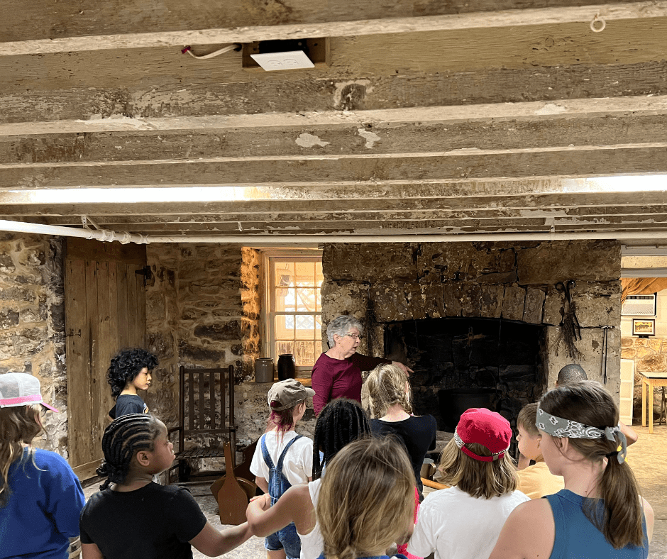 Students being led on a tour of the 1822 kitchen exhibit