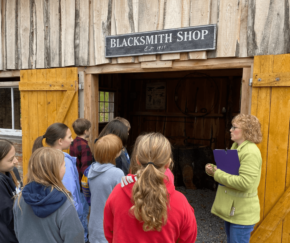 Kids being show the historic blacksmith shop exhibit on an Evergreen Heritage Center tour